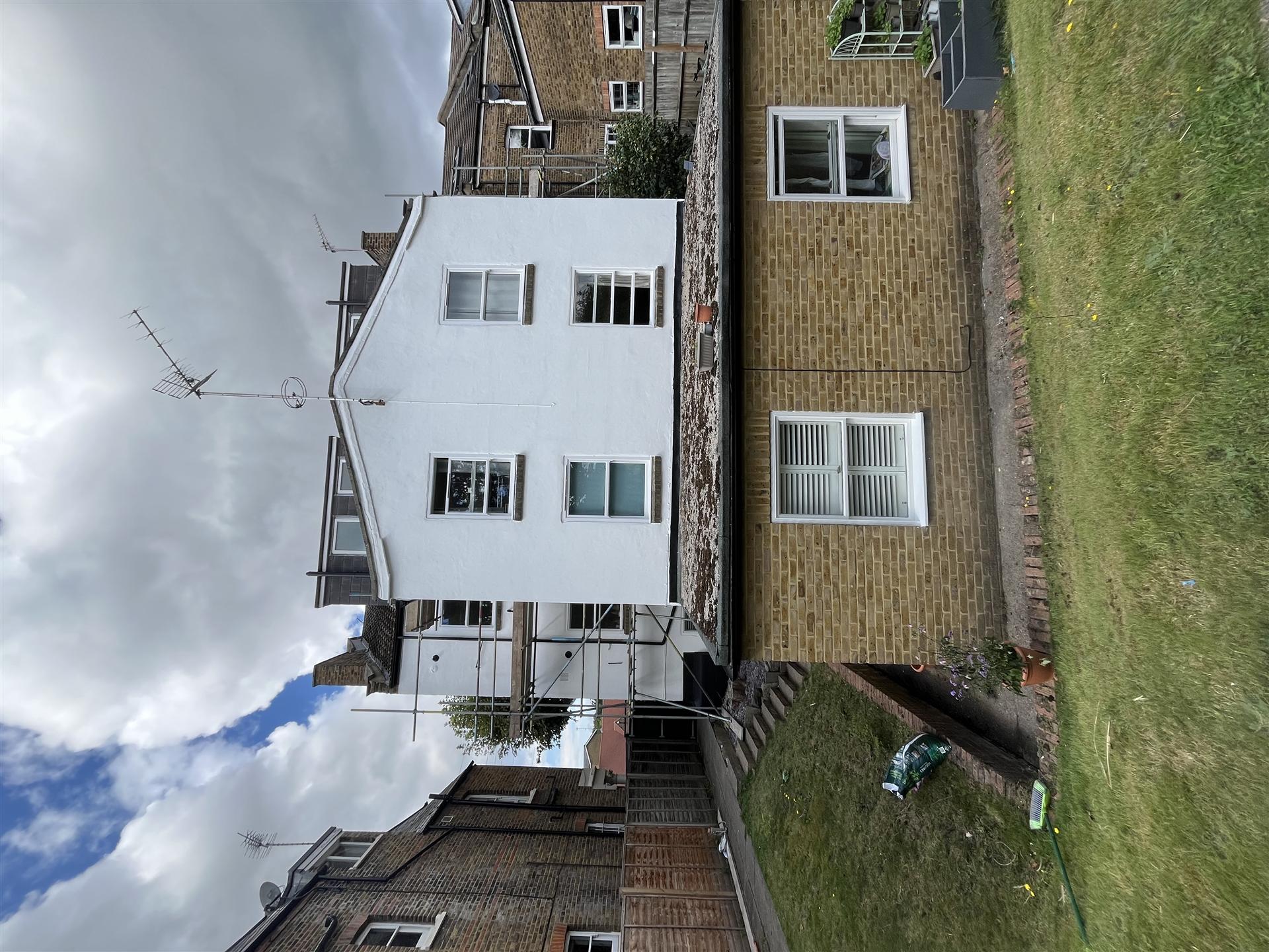 After, rendered gable end repainted brilliant white, Essex